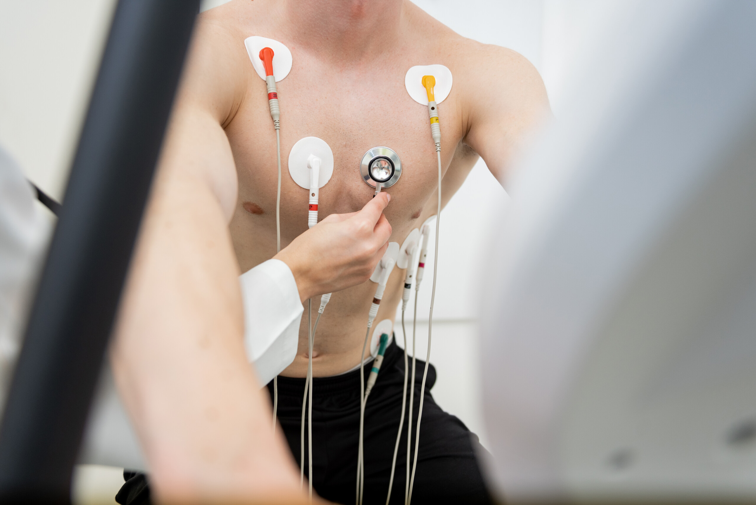 Determined athlete undergoing rigorous cardiac stress test in clinical setting
